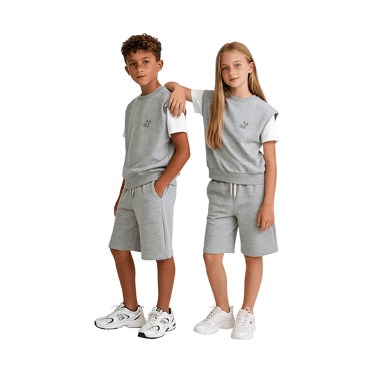 A boy and girl modeling the Ogender Heather Grey sweat vest and matching shorts, demonstrating a relaxed gender-neutral streetwear look for kids.