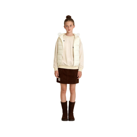 A young girl modeling the cream hooded quilted vest with rounded ears.