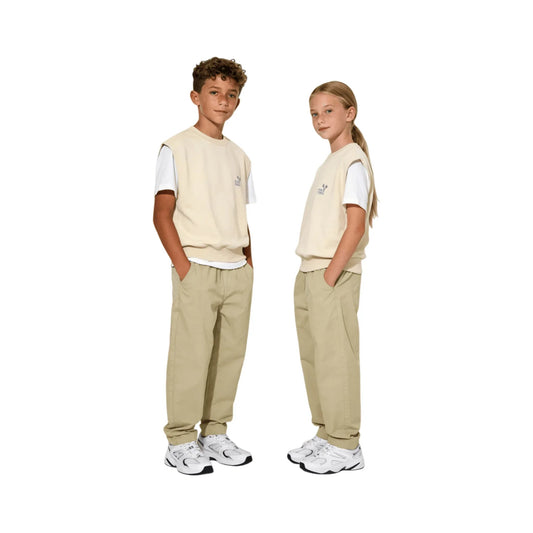 Child model wearing Ogender soft sage green pants with a minimalist tee.