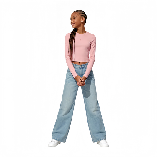 Teenager model wearing Ogender pink cropped long sleeve tee with smiley embroidery, styled for an urban aesthetic