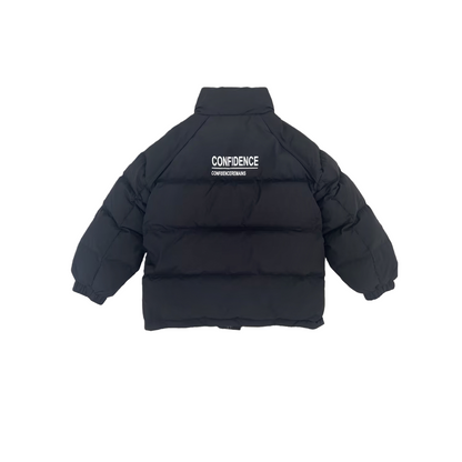 Front view of the ØGENDER kids' glossy black puffer jacket, showcasing the light-reflecting technical shell and minimalist industrial silhouette.