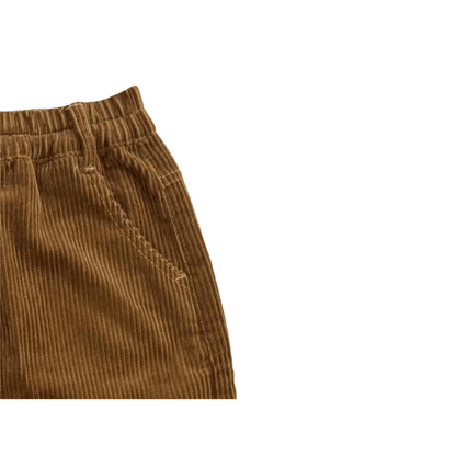 Detailed shot of the comfortable elastic waistband on the caramel corduroy skirt.