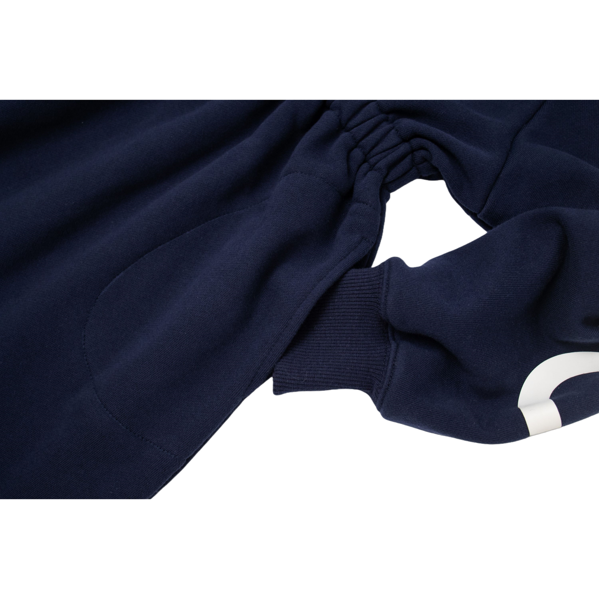 Detailed shot of the elastic waistband and the bold white typography printed along the sleeves.