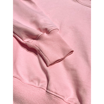 Detail view of 330g/m² heavyweight cotton fleece texture and ribbed cuffs on Ogender pink pullover.