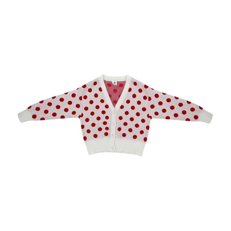 Front view of the ninø kids' white knit cardigan with large red polka dots and a V-neckline.