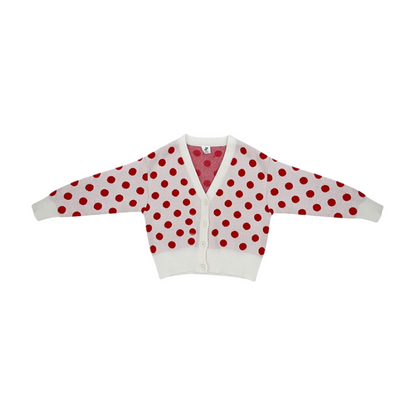 Front view of the ninø kids' white knit cardigan with large red polka dots and a V-neckline.