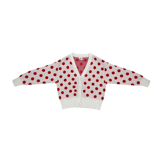 Front view of the ninø kids' white knit cardigan with large red polka dots and a V-neckline.