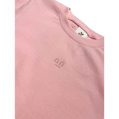 Close-up of high-quality smiley face embroidery on Ogender pink cropped top.