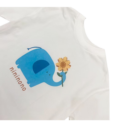 Close-up of the high-quality blue elephant and sunflower graphic print on the soft white cotton fabric.