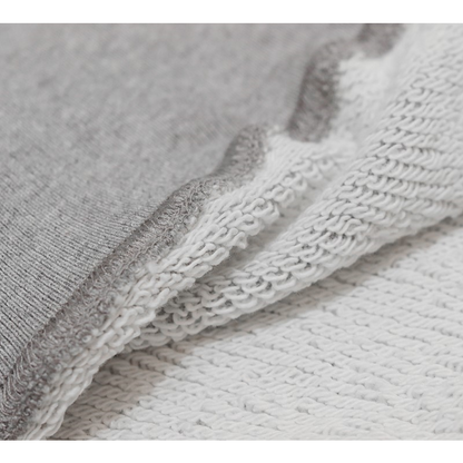 Close-up of the breathable 100% cotton fabric and the durable ribbed hem of the sweat vest.