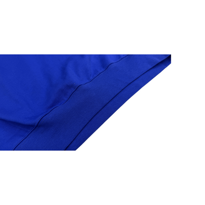 Detailed view of the clean-cut hemline on the Klein blue sweatshirt dress, designed for layering.