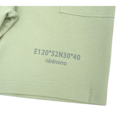 Detailed view of the coordinate graphic on the shorts, crafted with durable 3D silicone screen printing on heavyweight sage green cotton.