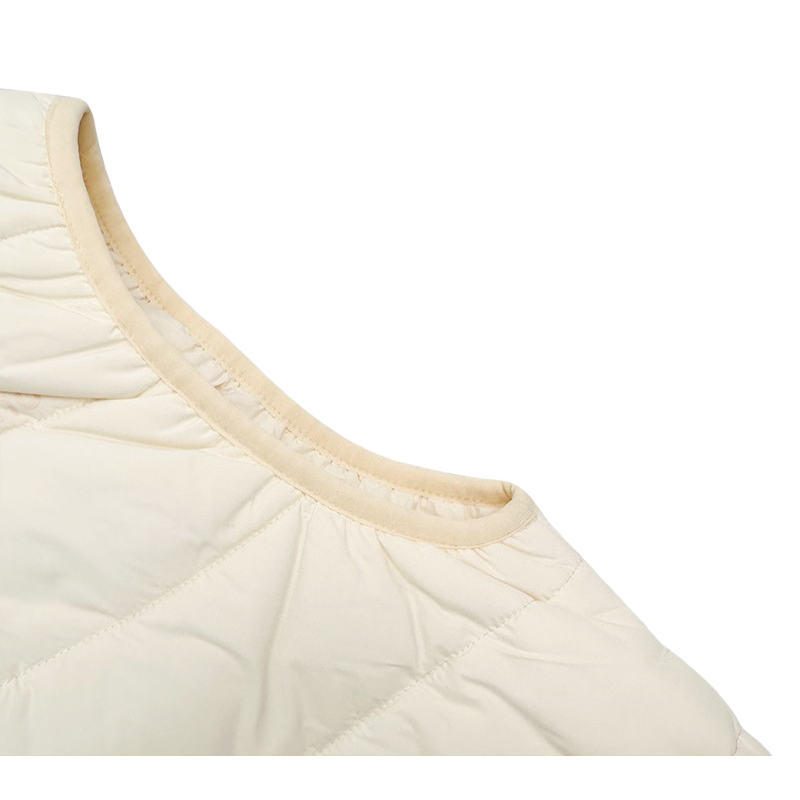 Close-up of the elastic binding at the armhole, designed for wind protection and comfort.