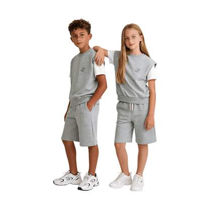 A boy and girl modeling the Ogender Heather Grey sweat vest and matching shorts, demonstrating a relaxed gender-neutral streetwear look for kids.