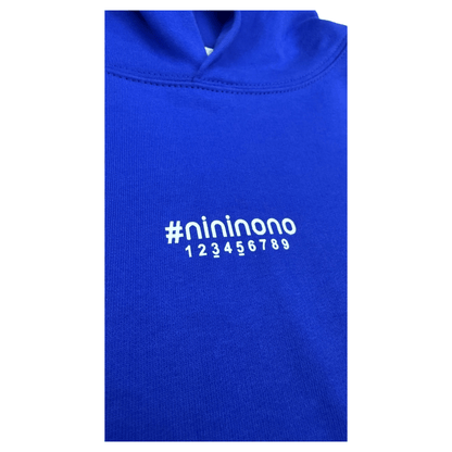 Close-up of the abstract number print and transparent tape logo effect on the chest of the blue hoodie.