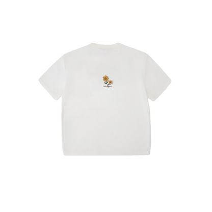 Back view of the white graphic tee highlighting the minimalist sunflower print centered on the upper back.