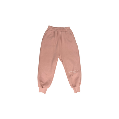 Front view of the unisex fleece-lined joggers in dusty rose, featuring a relaxed oversized fit.