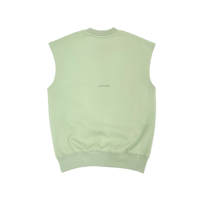 Back view of the sage green sleeveless tank top, highlighting the clean drop-shoulder silhouette and premium finish.