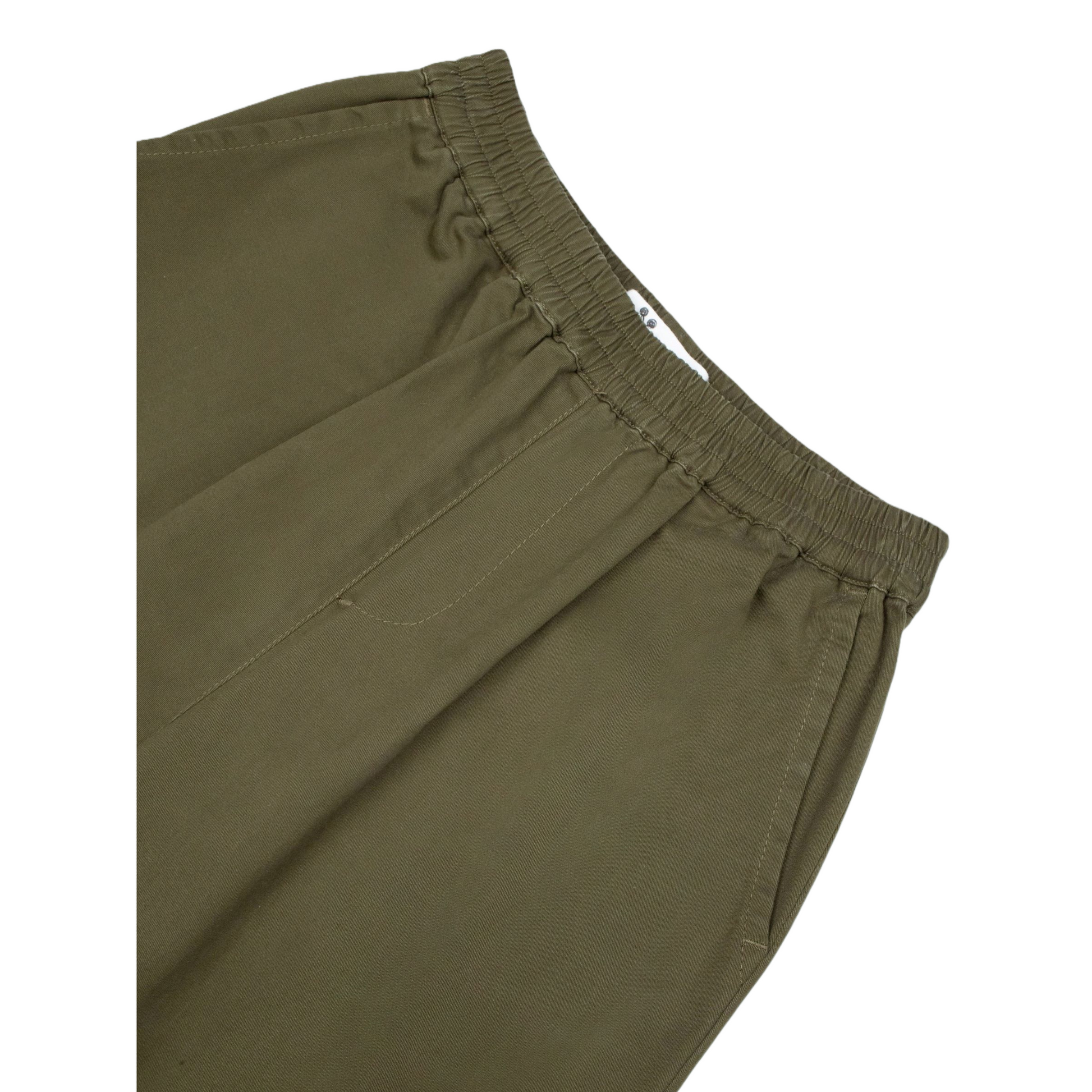 Close-up of the comfortable elastic waistband and precision stitching on the vintage utility pants.