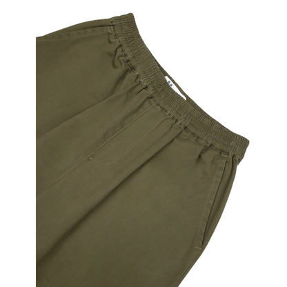 Close-up of the comfortable elastic waistband and precision stitching on the vintage utility pants.