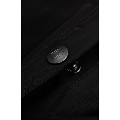 Detailed shot of the refined grey metal button on the durable water-resistant black fabric.