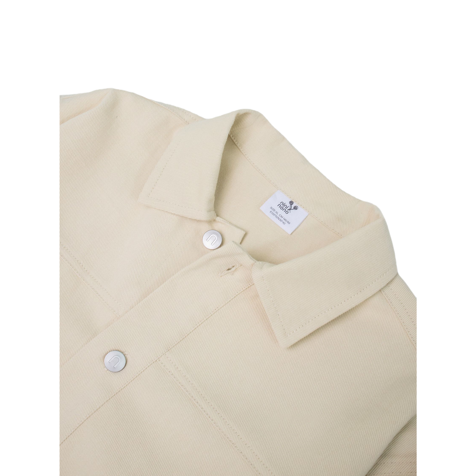 Close-up of the custom silver metal buttons on the khaki jacket, featuring the embossed "n" brand logo.