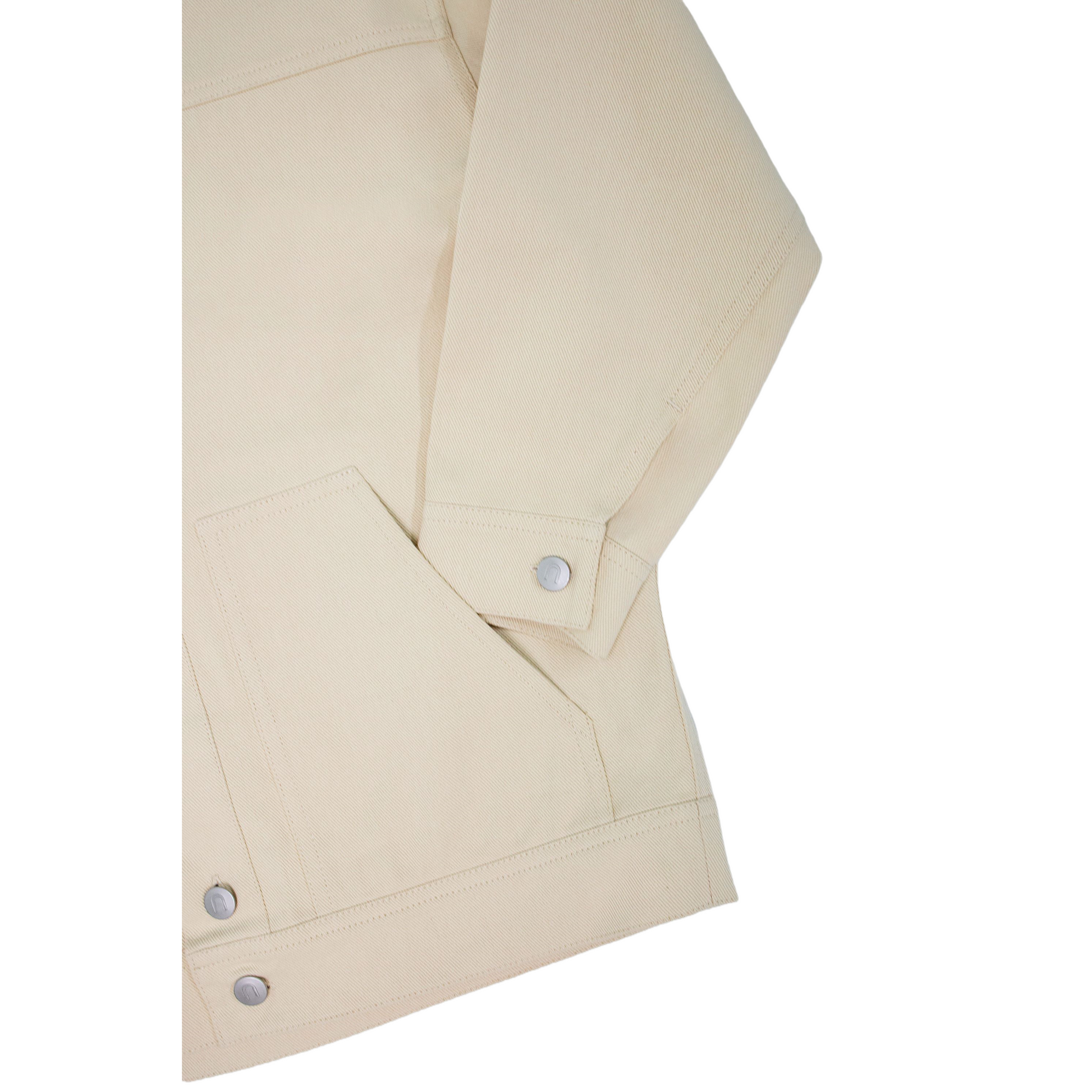 Close-up of the sleeve cuff and 100% cotton denim fabric, showcasing the premium stitching and durable texture.