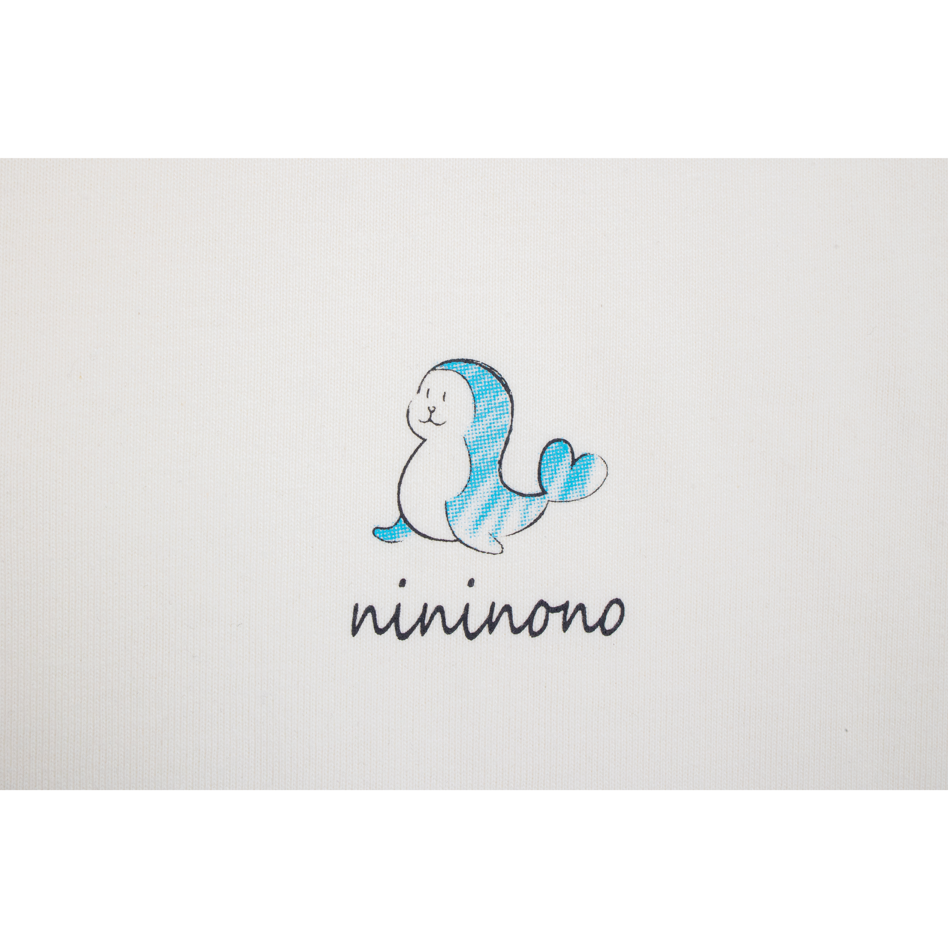 Close-up of the chest print featuring a playful dolphin graphic and the handwritten "nininono" brand name.