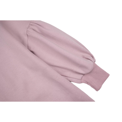 Detailed view of the voluminous puff sleeves and ribbed elastic cuffs.