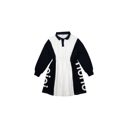 Front view of the ninø kids' color-blocking polo dress, featuring a dark navy and white design with an elastic waist and side logo graphics.