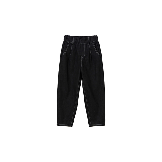 Ogender kids carrot fit denim jeans in black with contrast white stitching, front view.
