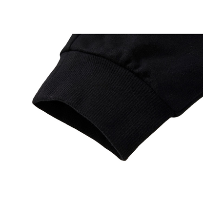 Close-up of the tapered ankle cuffs on the kids' cotton sweatpants, showing the durable ribbed construction designed to hold its shape during active play.