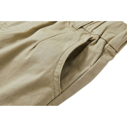 Close-up of the slanted side pocket and high-quality cotton fabric texture in light green.