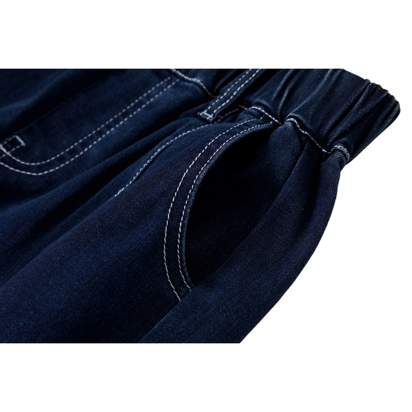 Detailed view of the deep front pocket and contrast white stitching on indigo denim.