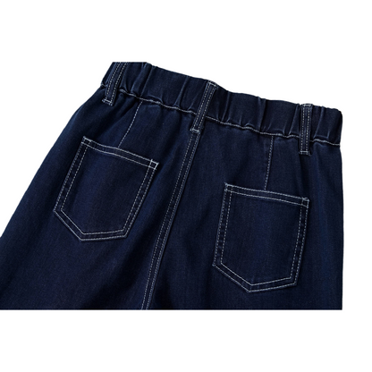 Detailed view of the back pocket with bold white contrast seams on dark blue denim.