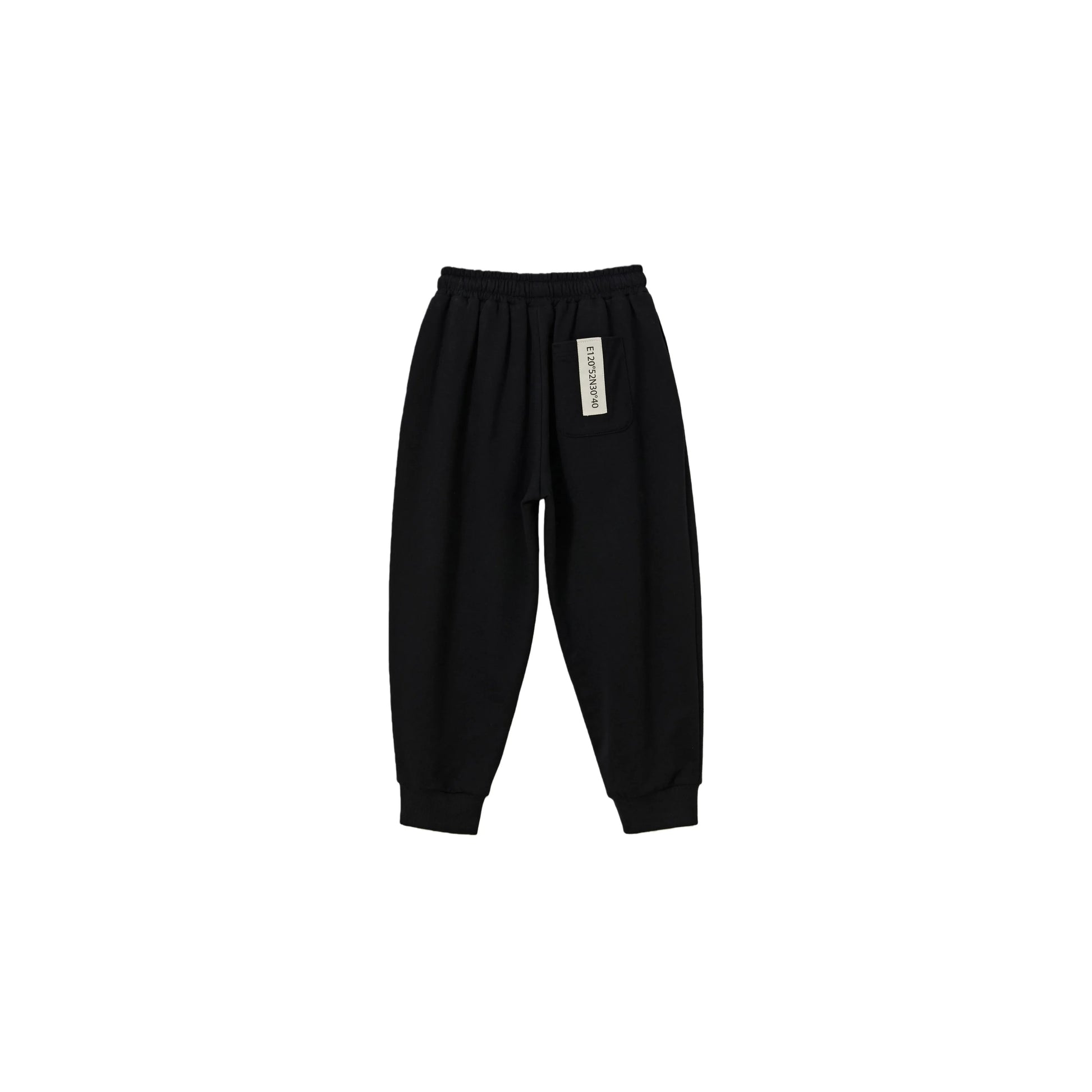 Back view of black kids sweatpants with signature industrial woven label.