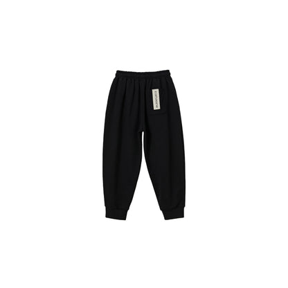 Back view of black kids sweatpants with signature industrial woven label.