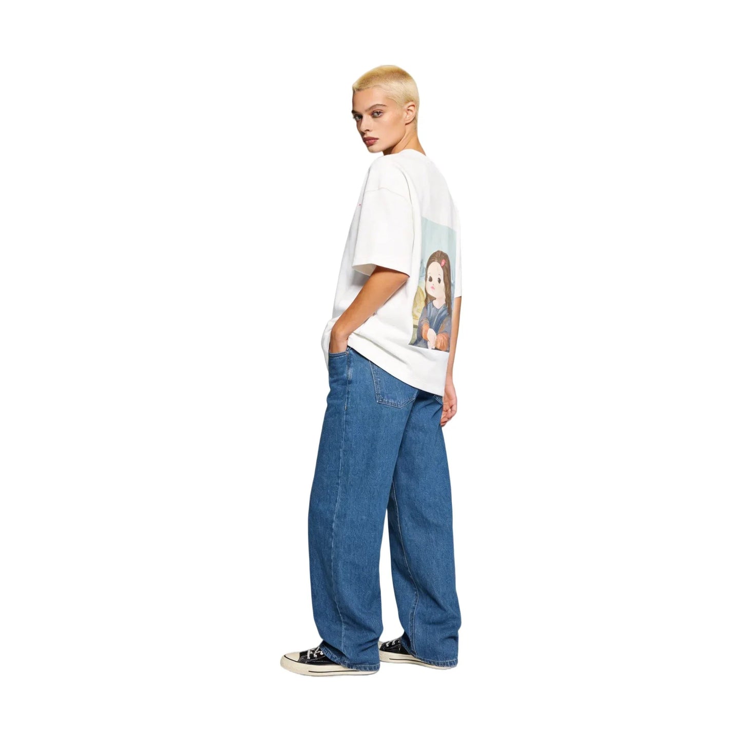 Side view of a buzz-cut female model wearing the Ogender 240 GSM white tee with the 'Smiling Girl' art print on the back. Paired with blue jeans for a modern, oversized streetwear look