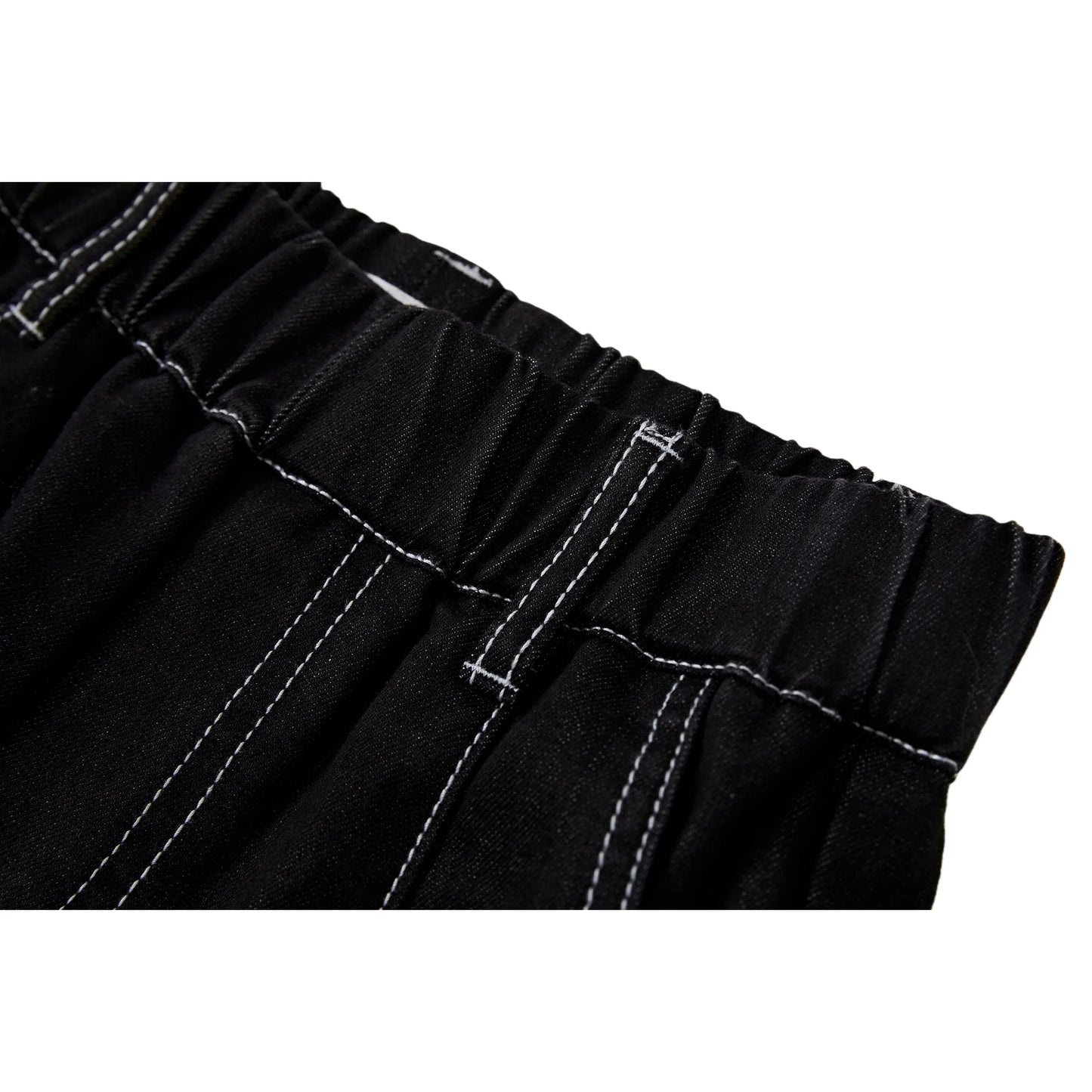 Close-up of the elasticated waistband and reinforced white contrast stitching on black denim.