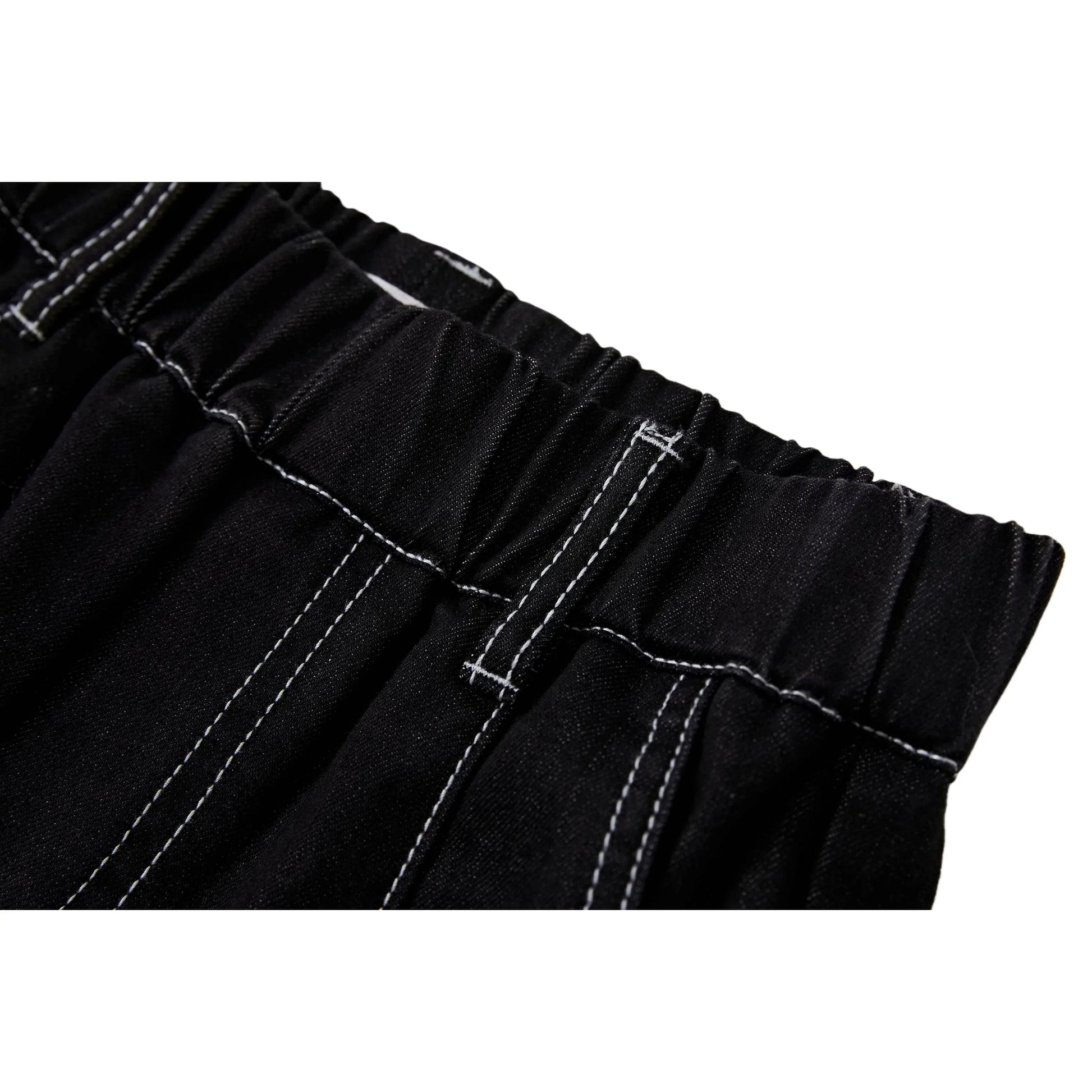 Close-up of the elasticated waistband and reinforced white contrast stitching on black denim.
