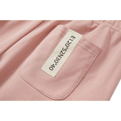 Close-up of the signature industrial woven label on the back pocket of the shorts.