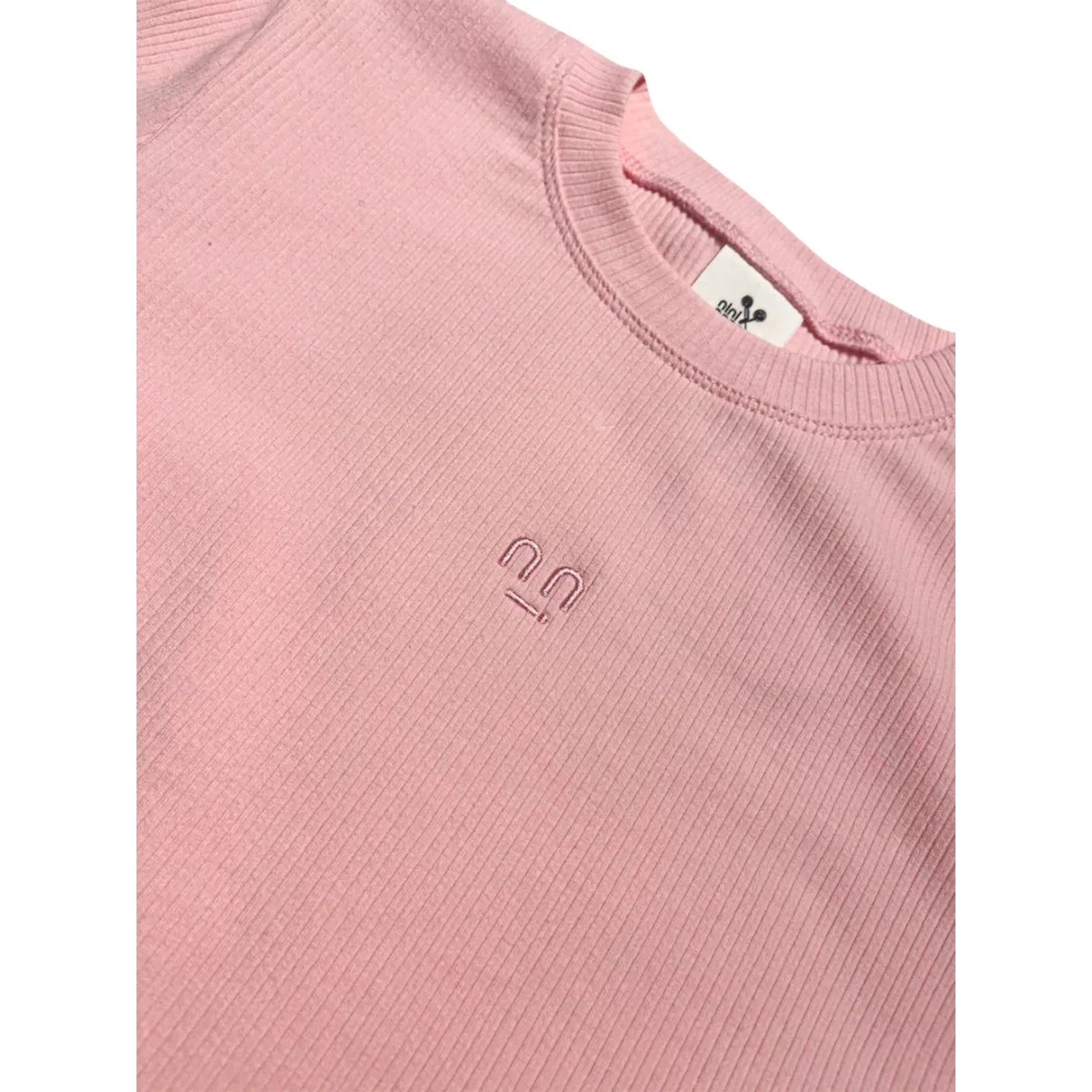 Close-up of the ribbed crew neckline and the high-quality smiley face embroidery on the Ogender pink tee.