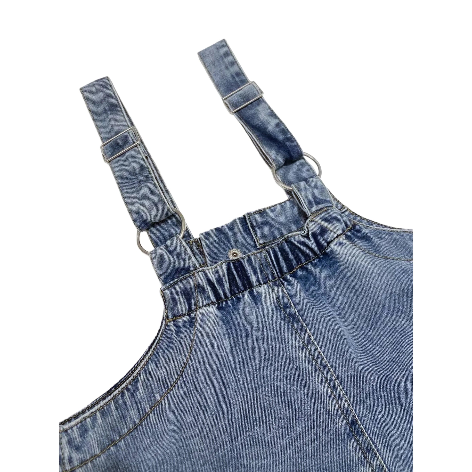 Close-up of the adjustable metallic strap buckles and the premium soft cotton denim texture.