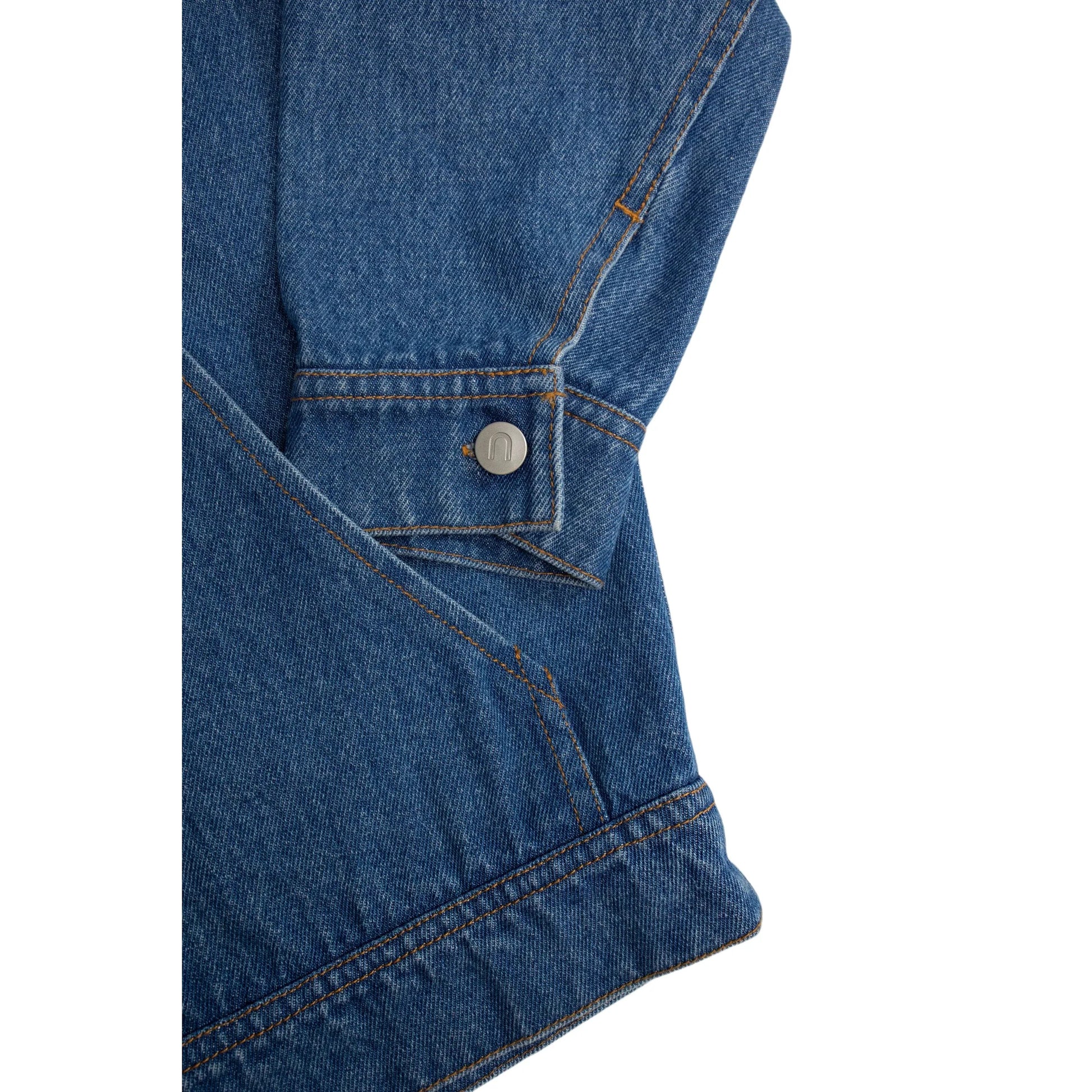 Detailed shot of the sleeve cuff with branded metal button and utility pocket stitching.