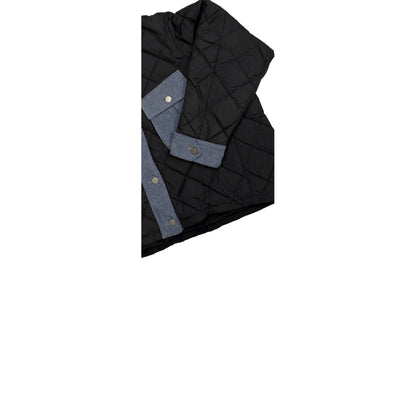 Close-up of the diamond-quilted texture and the denim-trimmed sleeve cuffs with snap buttons.