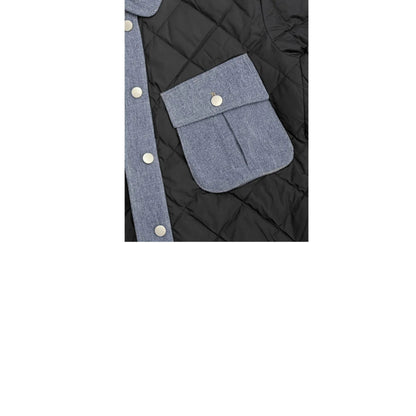 Detailed shot of the contrast denim chest pocket with a metal snap button on the quilted puffer.