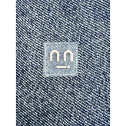 Close-up of the transparent silicone smiley patch precision-stitched on the chest
