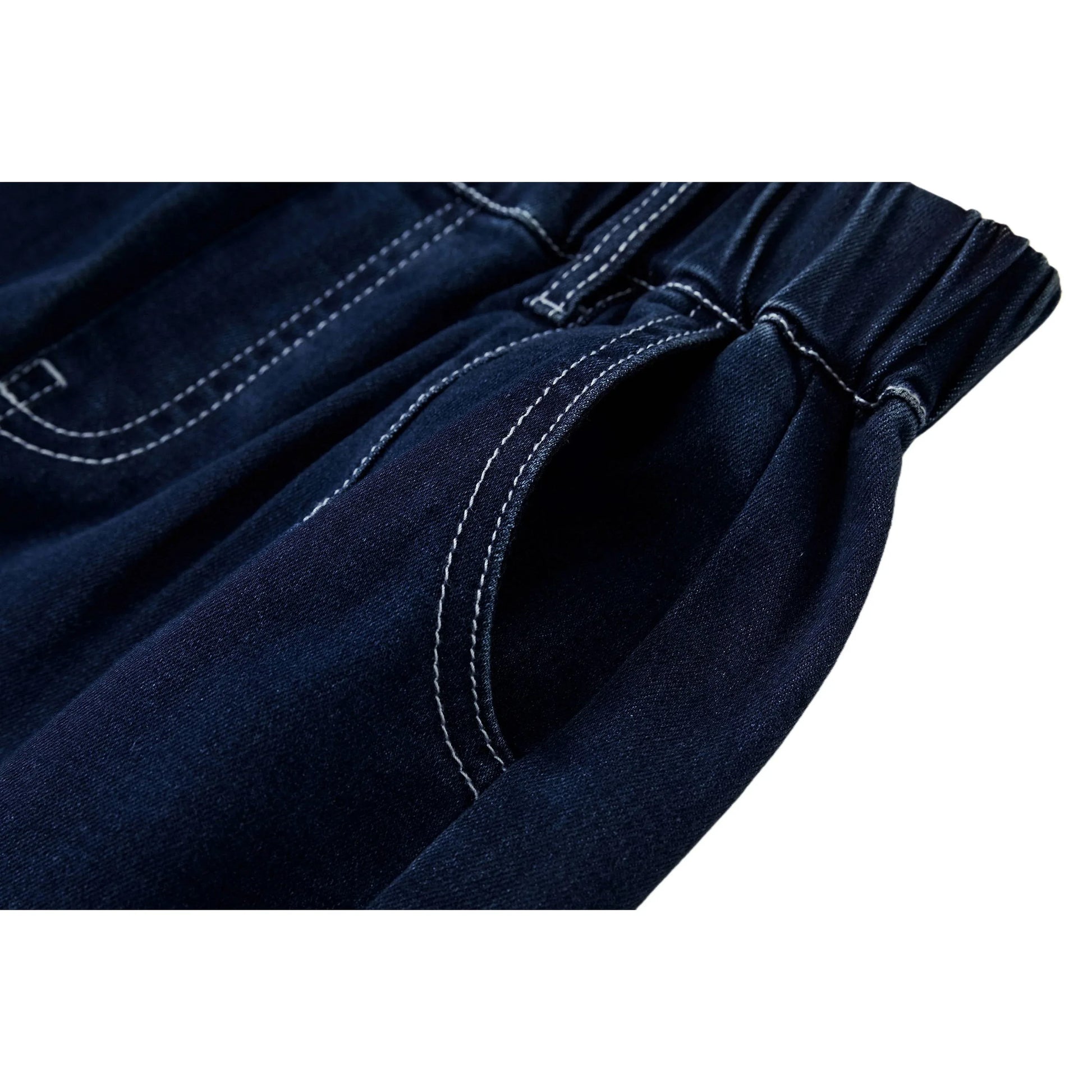 Close-up of the premium white contrast stitching on deep indigo soft-touch denim.