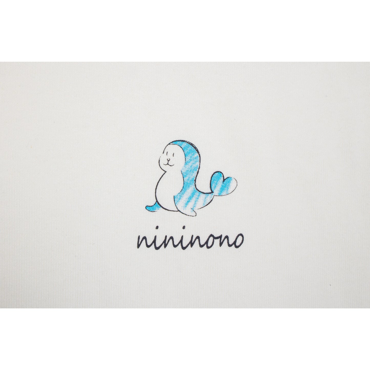 High-definition detail of the blue dolphin graphic and handwritten "nininono" text.