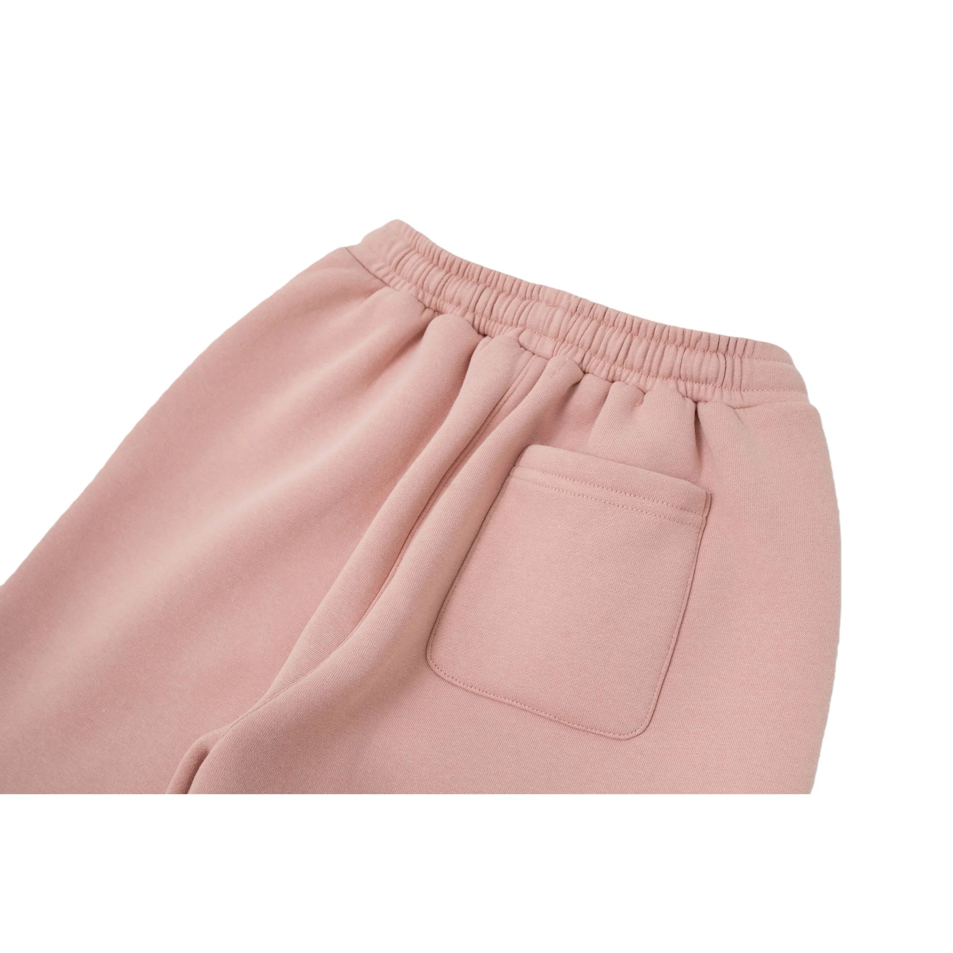 Close-up of the functional back pocket and the premium heavyweight sweatshirt fabric on the dusty pink joggers.